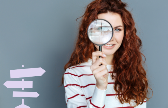 woman looking down magnifying glass