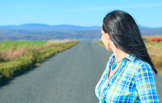 Woman looking back on road